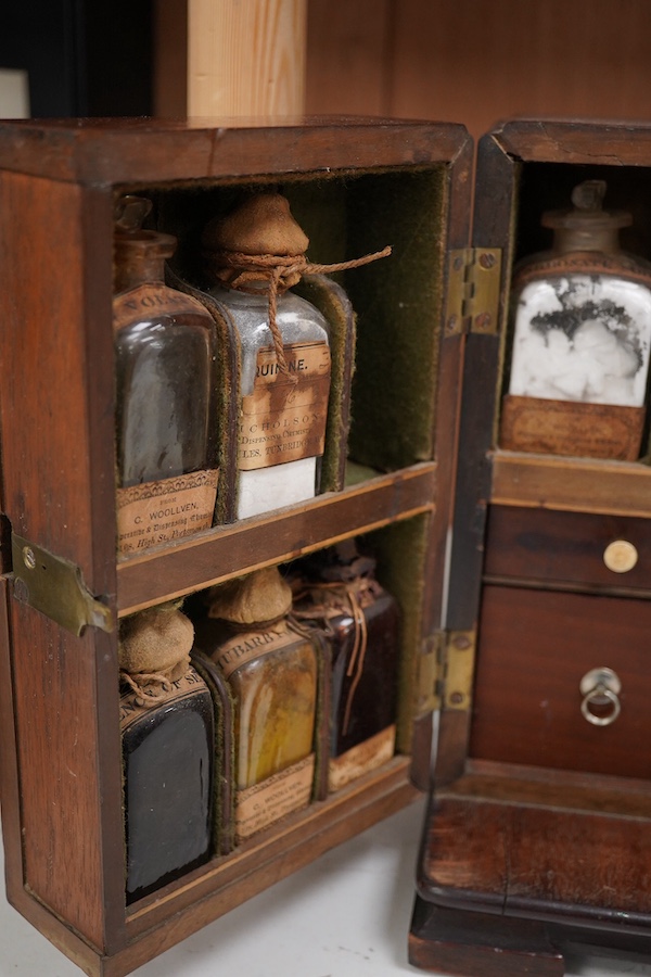 A 19th century mahogany apothecary cabinet, containing 20 bottles of various medicinal compounds and poisons, some sealed, all with paper labels, mainly for ‘C. Woollven, Operative & Dispensing Chemist, 108, High Street,